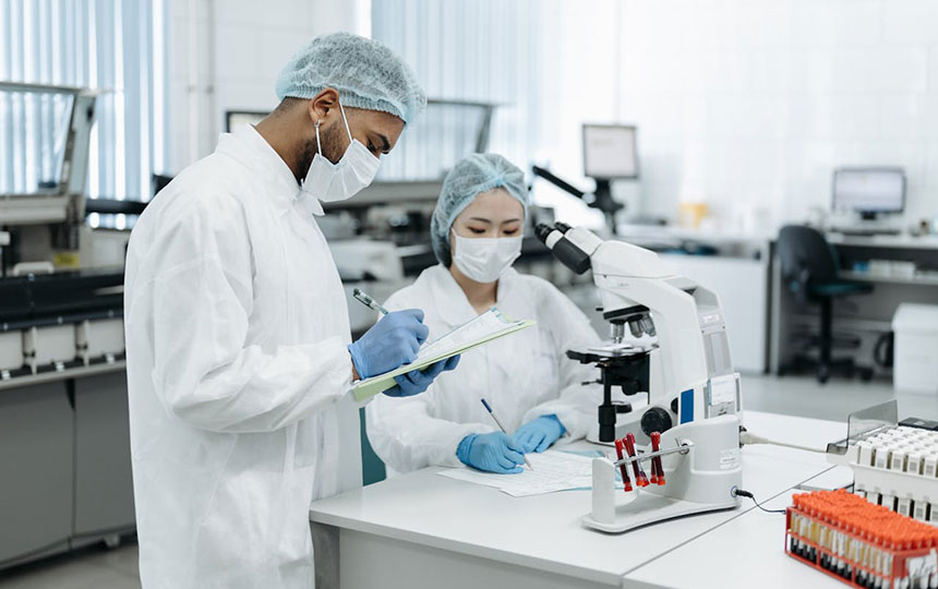 male and female scientists taking notes